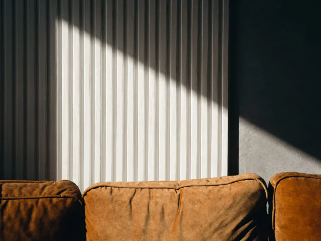 A ray of sun on a textured wall in a room.