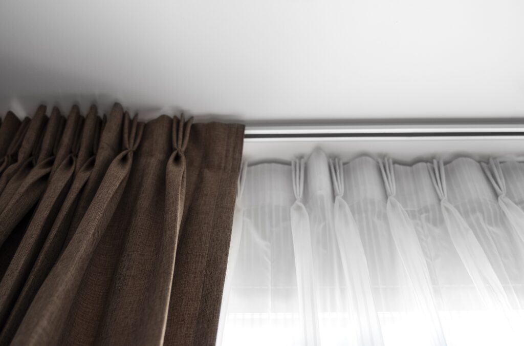 Electric apartment curtain rods in white shade with curtains